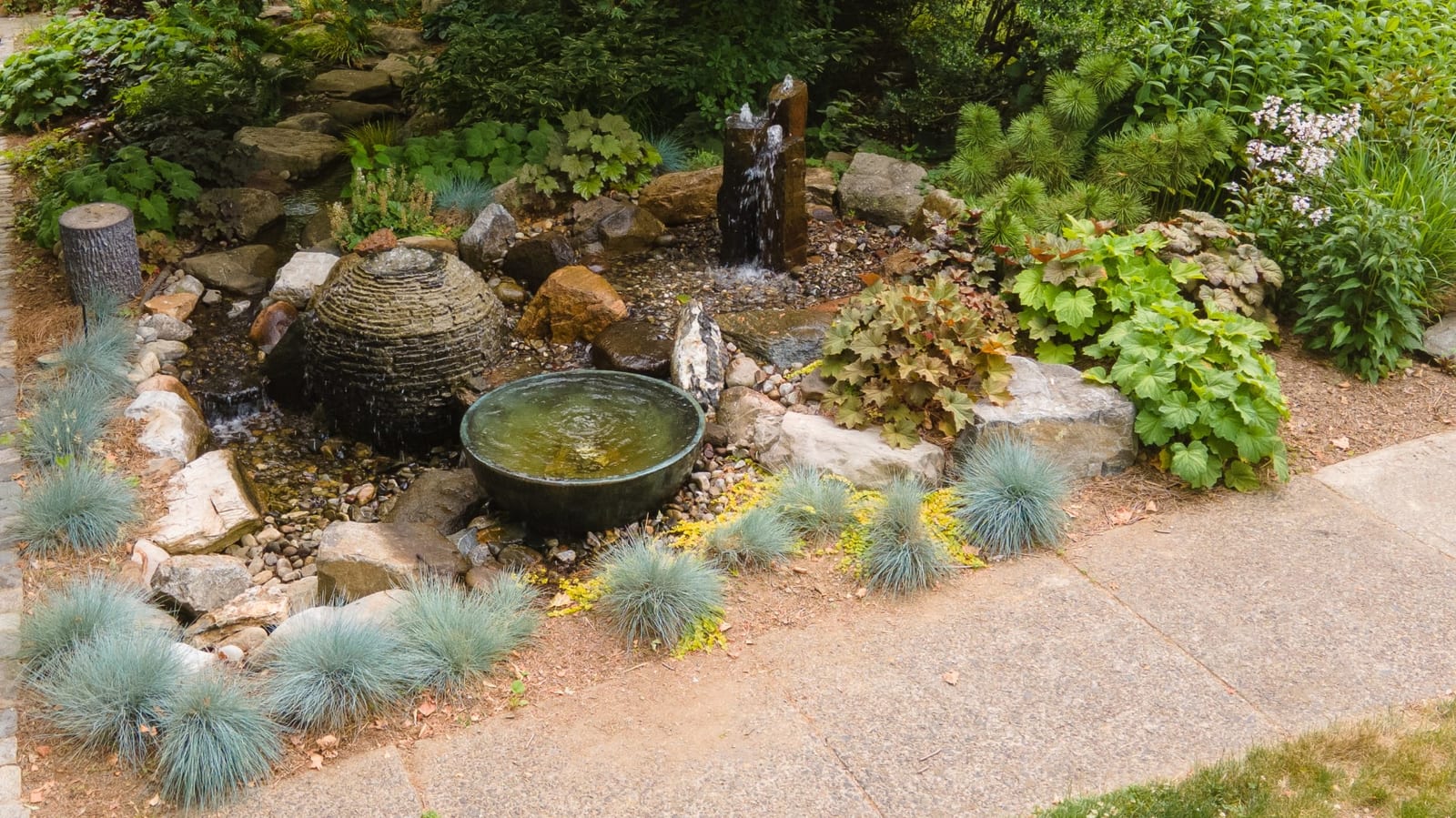 Beehive fountain and spillway bowl with blue fescue plantings by AquaReale Philadelphia