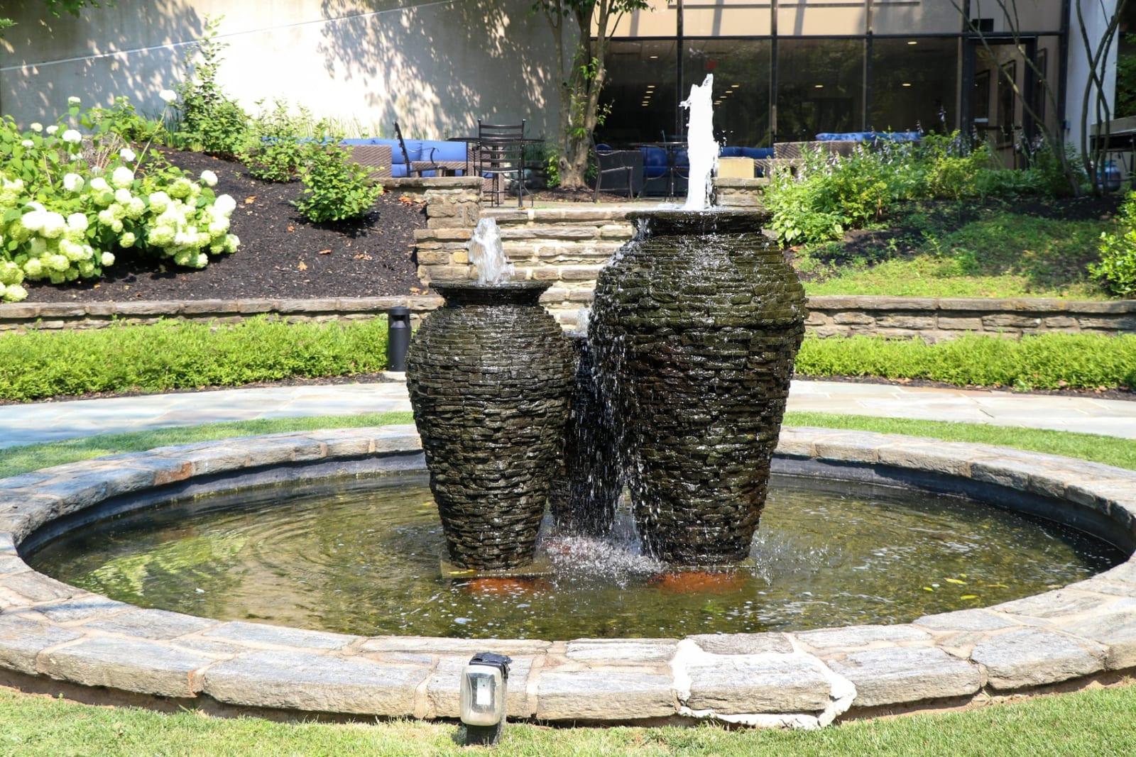 Stacked slate urn fountains in a formal commercial pond by AquaReale Philadelphia