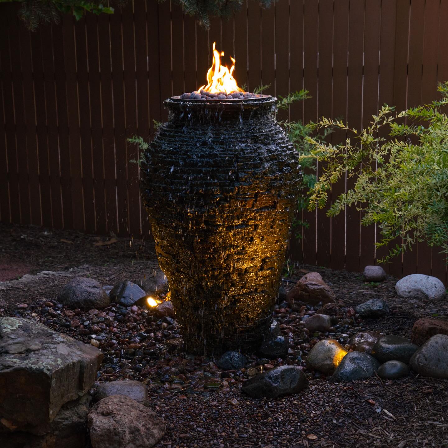 Fire and water urn feature lit at night by AquaReale Philadelphia
