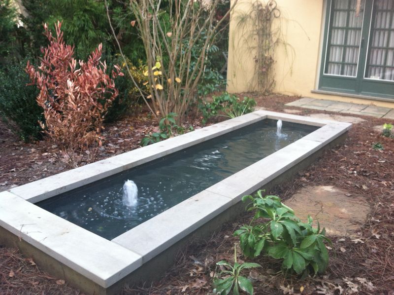 Rectangular formal pond with fountain jets