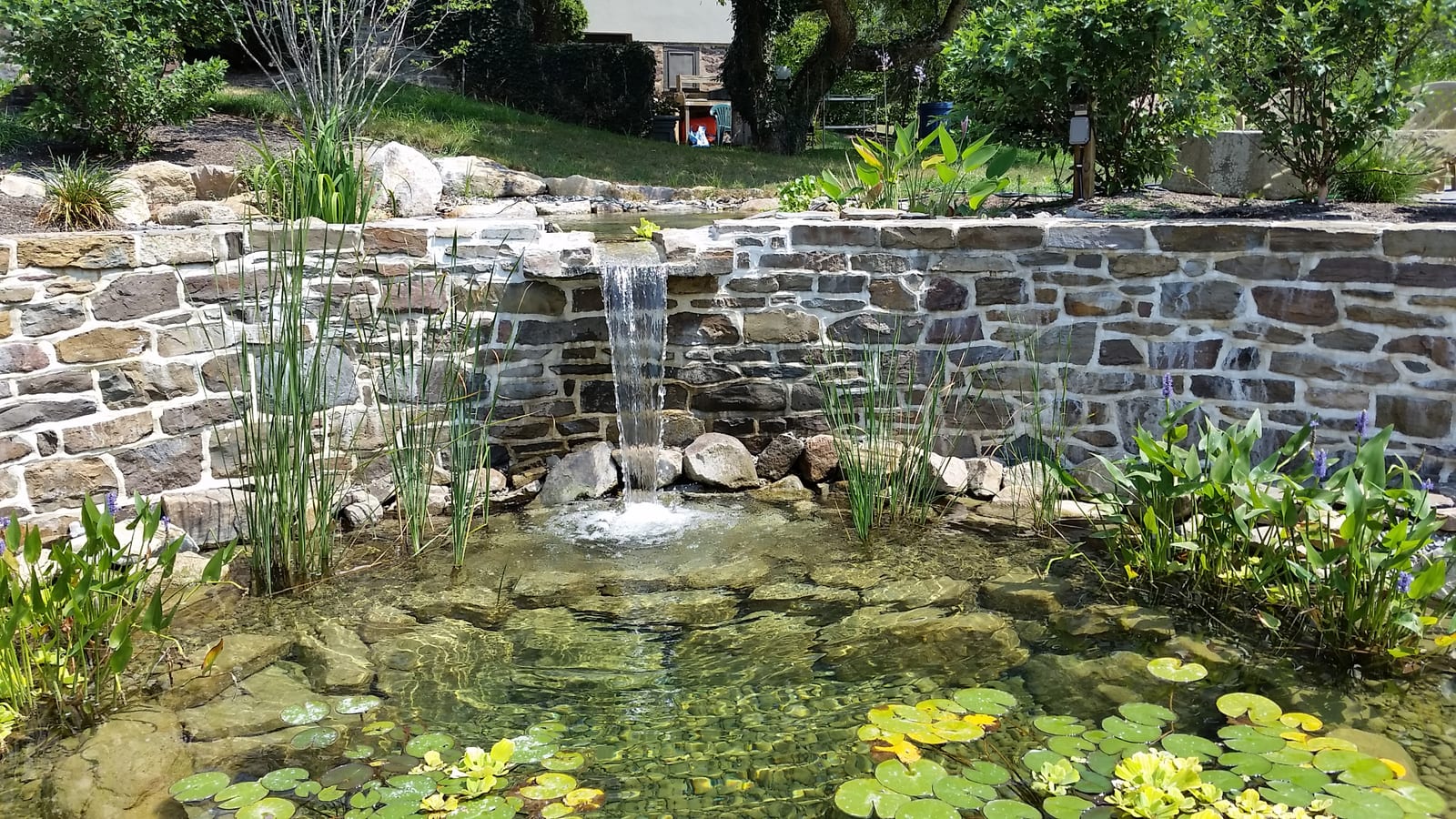 Stone wall formal pond with waterfall