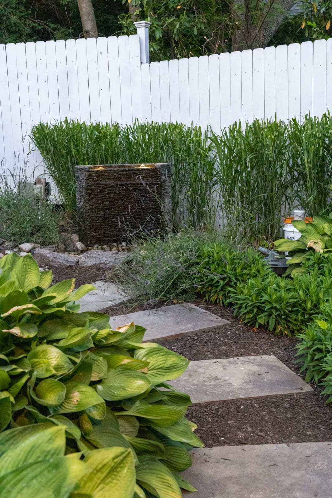 Slate fountain along a stepping stone garden path with hostas by AquaReale Philadelphia