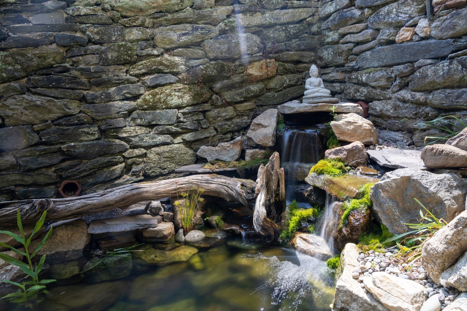 Zen waterfall feature with Buddha statue