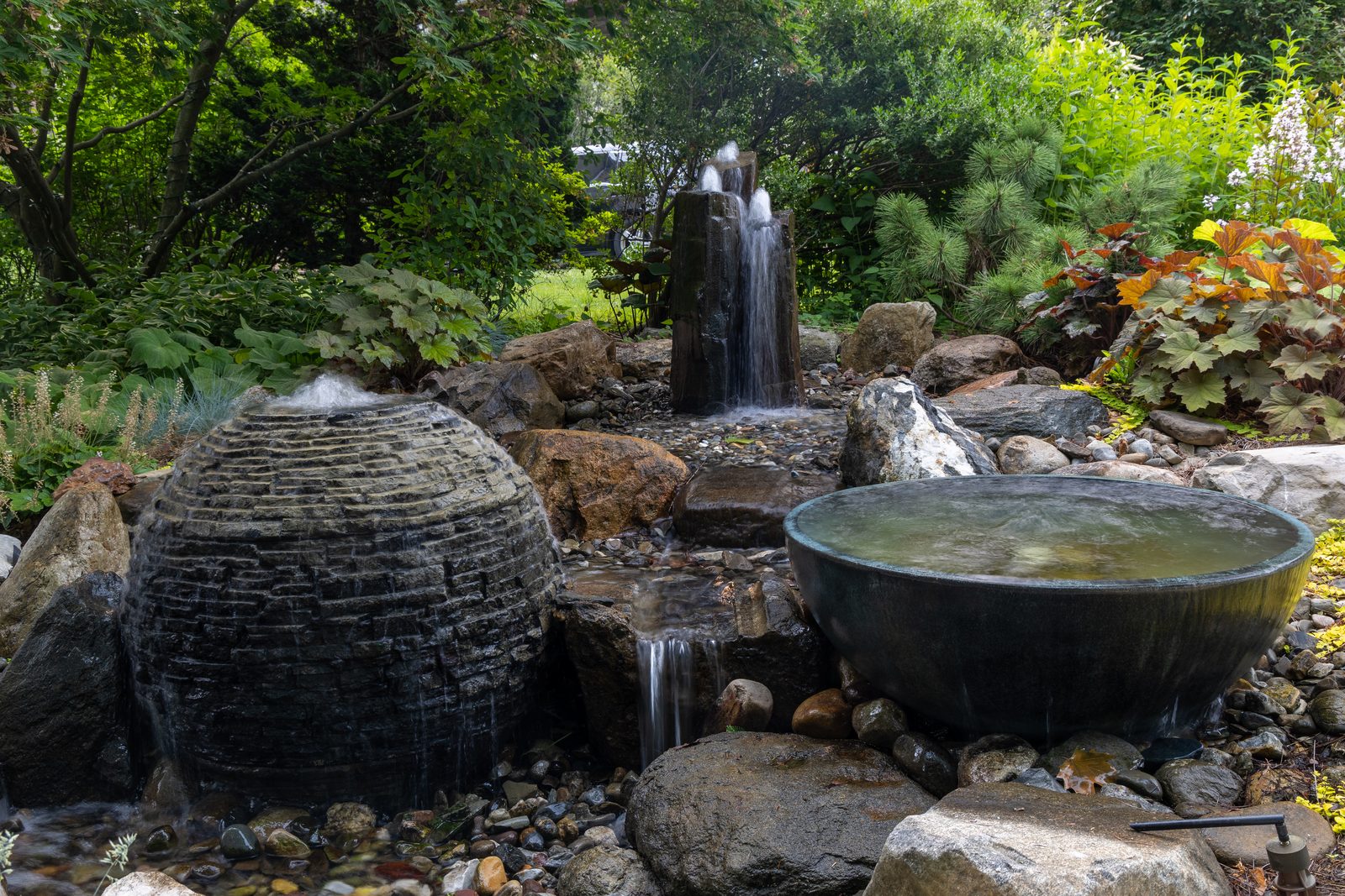 Front yard water feature with slate sphere, spillway bowl and basalt column by AquaReale Philadelphia