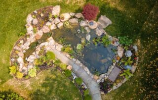 Aerial view of backyard garden pond with landscaping.